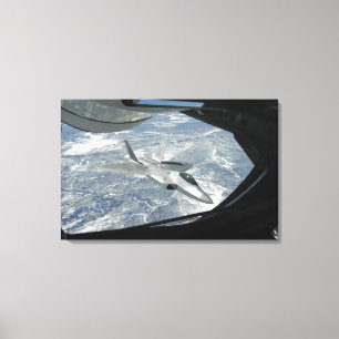 An F-22 Raptor banks away from a KC-135 Canvas Print