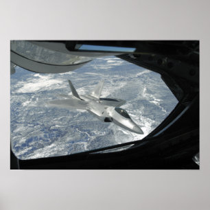 An F-22 Raptor banks away from a KC-135 Poster