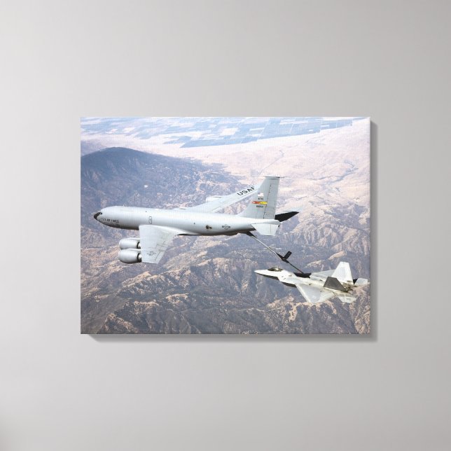 An F-22 Raptor receives fuel from a KC-135 Canvas Print (Front)