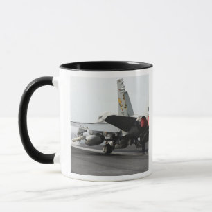 An F/A-18C Hornet launches from the flight deck 2 Mug