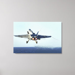 An F/A-18C Hornet launches from the flight deck Canvas Print