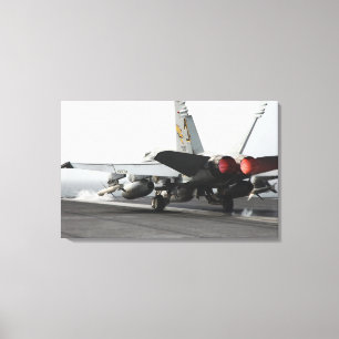 An F/A-18C Hornet launches from the flight deck Canvas Print