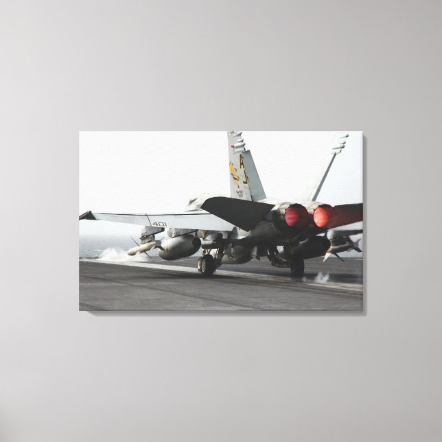 An F/A-18C Hornet launches from the flight deck Canvas Print (Front)