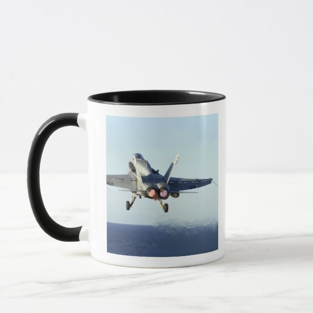 An F/A-18C Hornet launches from the flight deck Mug (Left)