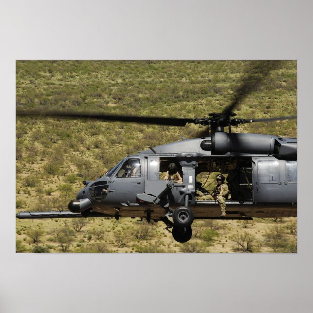 An HH-60 Pave Hawk flies over the desert Poster (Front)