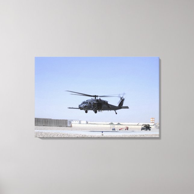 An HH-60G Pave Hawk taking off from Camp Bastio Canvas Print (Front)