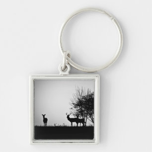 An image of some deer in the morning mist keychain