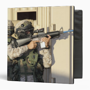 An infantry scout aims his weapon binder