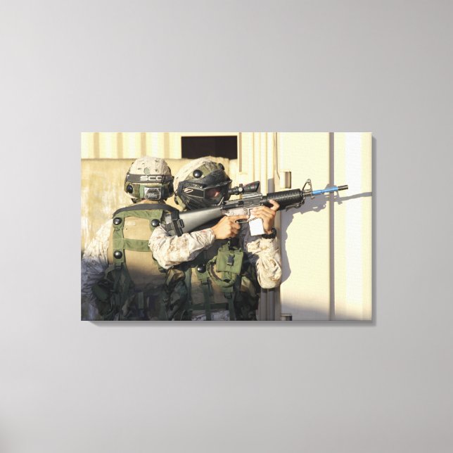 An infantry scout aims his weapon canvas print (Front)