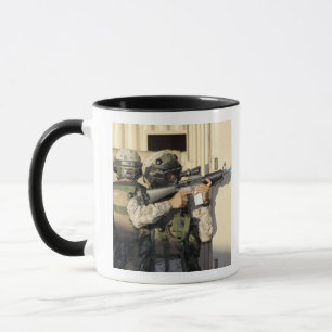 An infantry scout aims his weapon mug