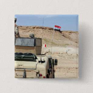 An instructor watches as an Iraqi army soldier 2 Inch Square Button