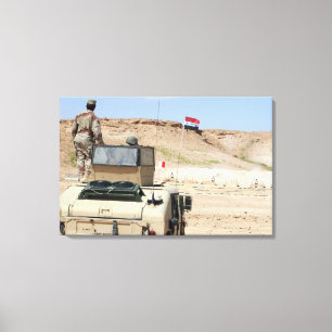 An instructor watches as an Iraqi army soldier Canvas Print
