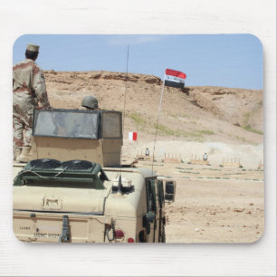 An instructor watches as an Iraqi army soldier Mouse Pad