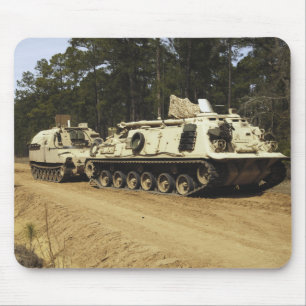 An M-88 recovery vehicle begins to tow an M992 Mouse Pad