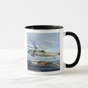 An MH-60S Seahawk prepares to deliver ammunitio Mug