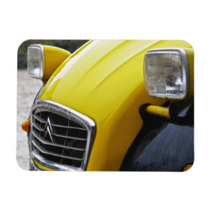 An old black and yellow Citroen 2CV 2 CV, detail Magnet