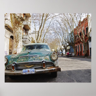 An old car rusty and flaky color parked in the poster