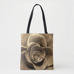 An old-fashioned rose close up, wet with water dro tote bag