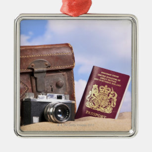 An old leather suitcase, retro camera and metal ornament