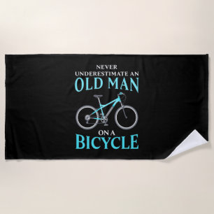 An Old Man On A Bicycle Beach Towel