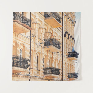 An old yellow house with wrought-iron balconies. f tapestry