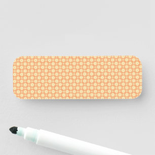 an orange and white background with a pattern name tag