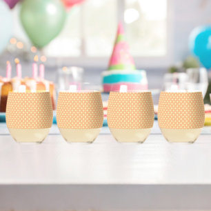 an orange and white background with a pattern stemless wine glass
