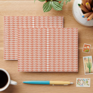 an orange and white pattern on a white background envelope