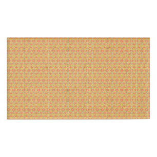 an orange and yellow background with a pattern name tag