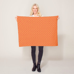 an orange and yellow background with small squares fleece blanket