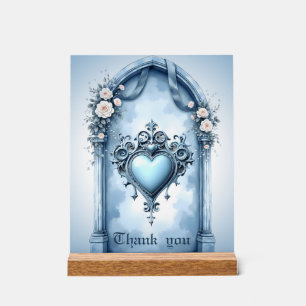 An ornate light blue archway with floral accents, acrylic sign