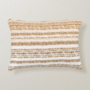 An ornate textile design featuring orange and whit accent pillow