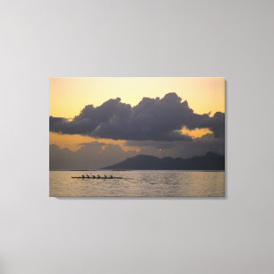An outrigger canoe team practices off the coast canvas print