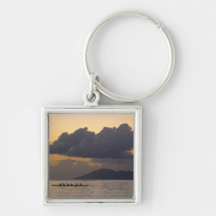 An outrigger canoe team practices off the coast keychain