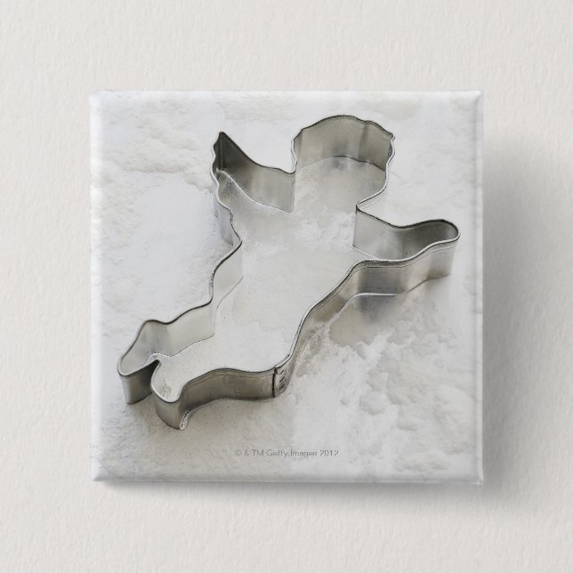 Angel shaped cookie cutter, with flour, close-up 2 inch square button (Front)