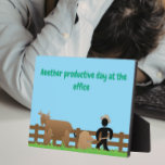 Another Productive Day at the Office Plaque<br><div class="desc">Bring some sarcastic humor to the workplace with this funny office-themed design featuring the caption “Another Productive Day at the Office.” The design shows a hardworking figure cleaning up while a nearby bull stands by, delivering a classic visual punchline that anyone who works in an office will instantly understand. Perfect...</div>