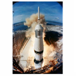 Apollo Saturn V Rocket launch to Moon 1969 Photo Sculpture Magnet<br><div class="desc">On July 16th, 1969, with the world watching in nervous anticipation, a pillar of fire erupted from Kennedy Space Center. The colossal Saturn V rocket, the most powerful machine ever built at the time, thundered skyward, carrying a spacecraft with three astronauts on a historic journey. The ground trembled, buildings shook,...</div>