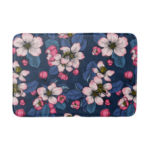 Apple blossom on a dark blue bath mat