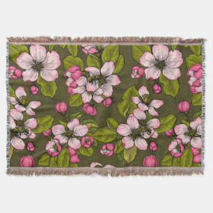 Apple blossom on dark green throw blanket