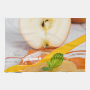 Applesauce with cinnamon and orange spoon kitchen towel