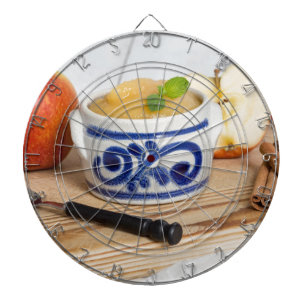Applesauce with cinnamon in stoneware bowl dartboard