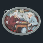 April Fool, 1943 Oval Belt Buckle<br><div class="desc">Artist: Norman Rockwell | The first in a series of 3 painted by Norman Rockwell in honour of April Fool's Day. This is more than a couple at table by a fireplace. Can you find the many comical errors in the illustration?</div>