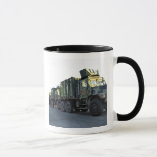 Armoured trucks sit on the pier at Morehead City Mug