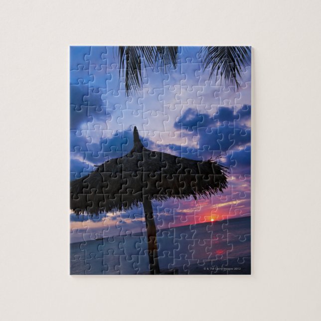 Aruba, silhouette of palapa on beach at sunset 2 jigsaw puzzle (Vertical)