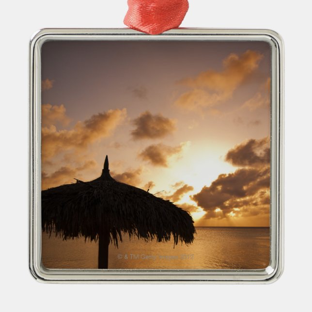 Aruba, silhouette of palapa on beach at sunset metal ornament (Front)