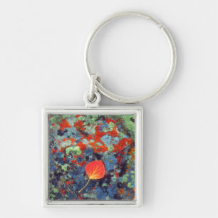 Aspen leaf on a lichen covered rock keychain