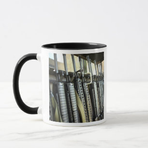 Assault rifles stand ready on the weapons rack mug