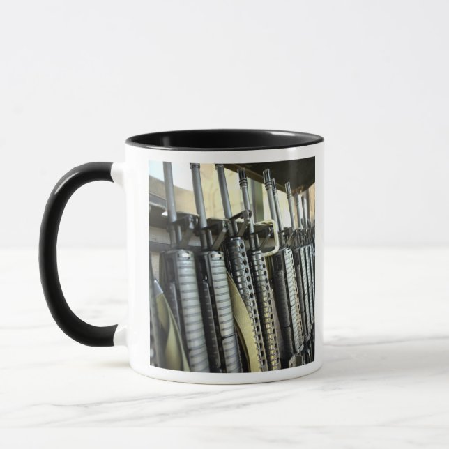 Assault rifles stand ready on the weapons rack mug (Left)