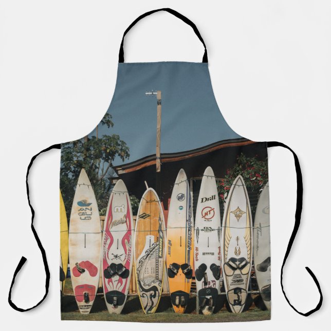 Assorted surfing boards stands on open field in th apron (Front)