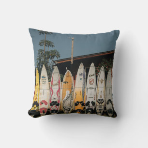 Assorted surfing boards stands on open field in th throw pillow